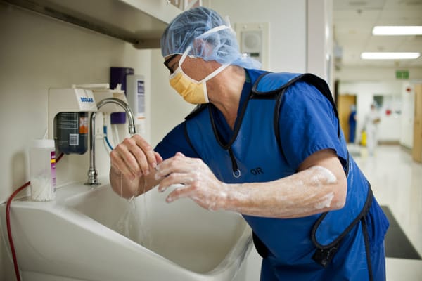 A surgeon scrubs his hands and arms before going into the operating room at Riverside County Regional Medical Center.